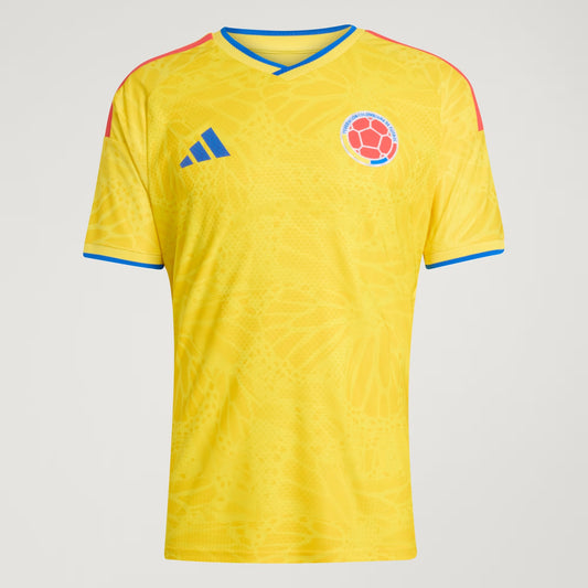 Yellow sports jersey with logo and Colombian flag on a gray background